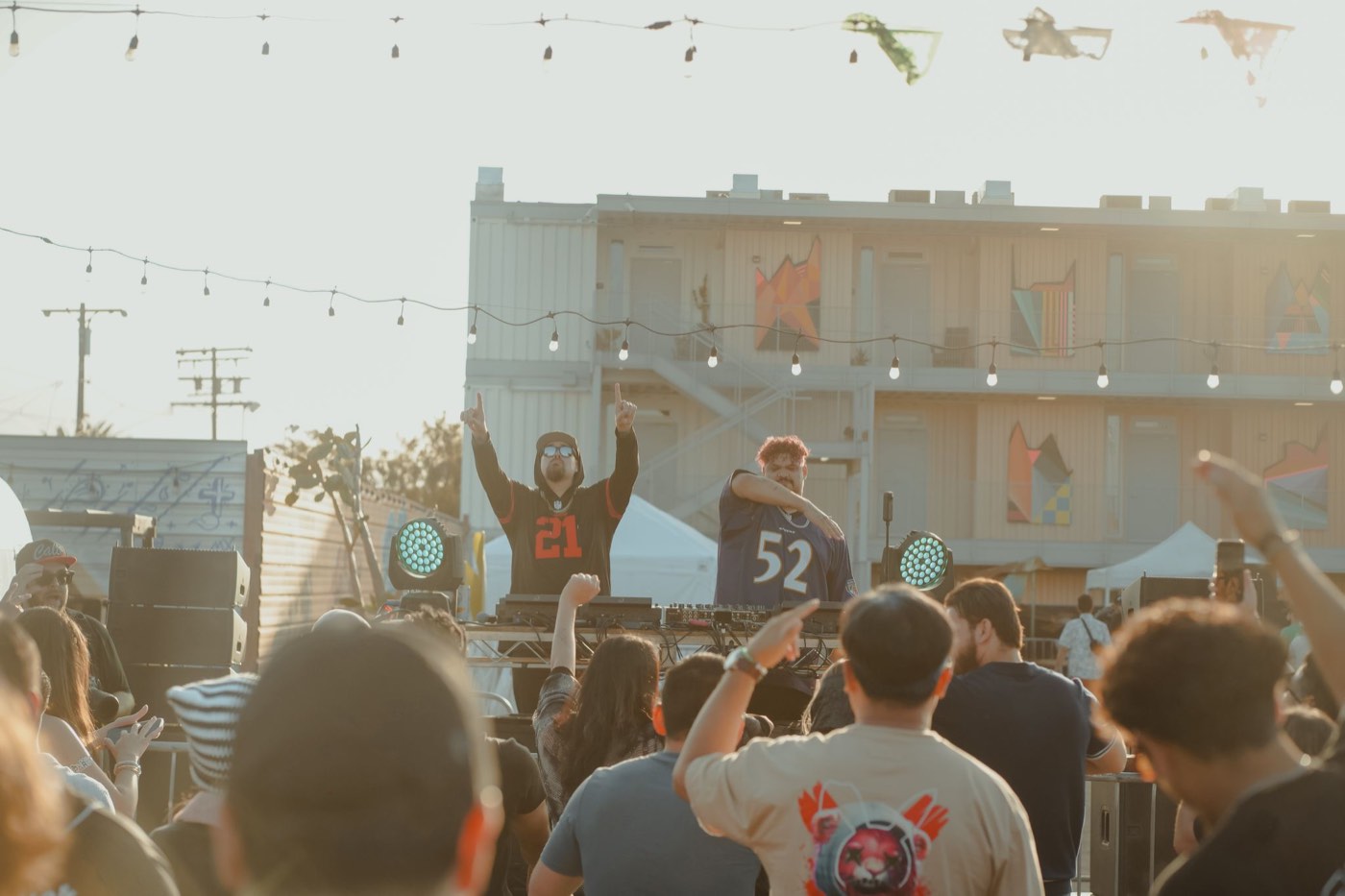Daytime festival crowd in front of the stage at golden hour