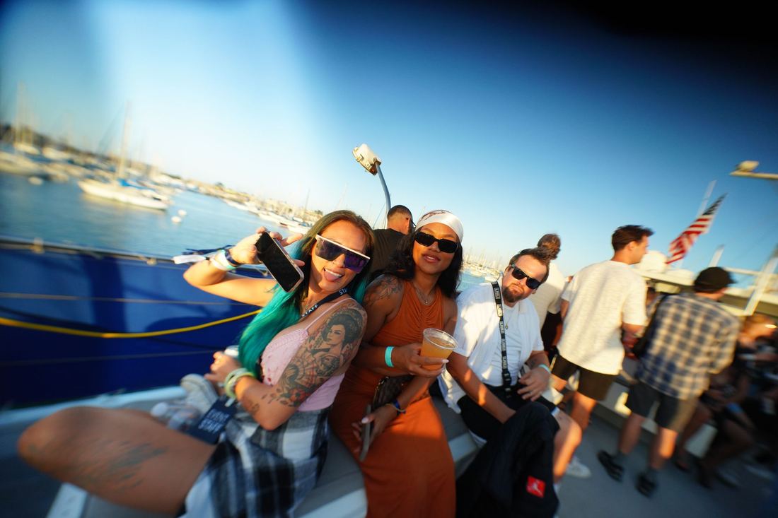 Crowd on the open deck in daylight with the bay behind