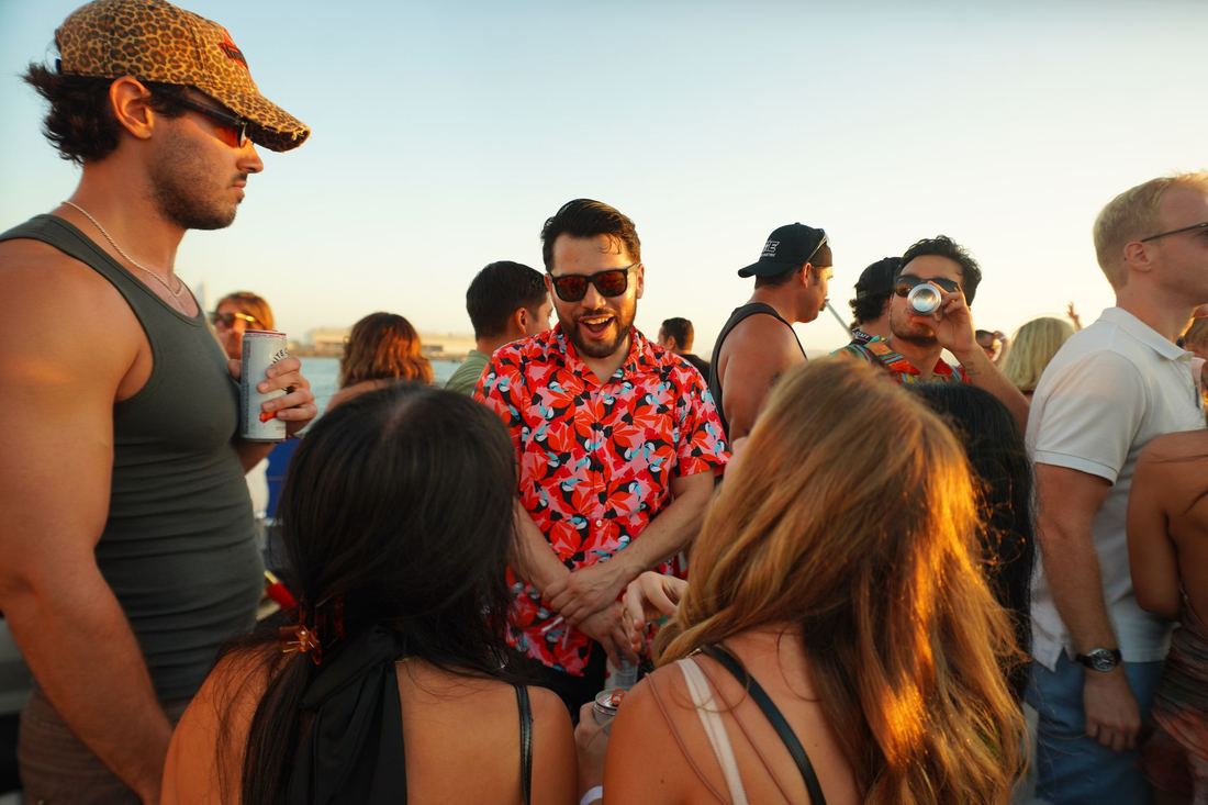 Friends packed together on deck in the sun