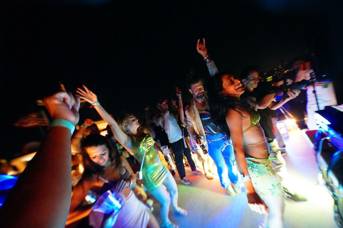 Arms in the air on the deck at night